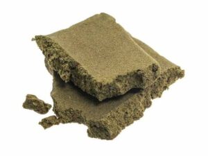 Moroccan hash blocks with crumbly texture and light brown color isolated on white background